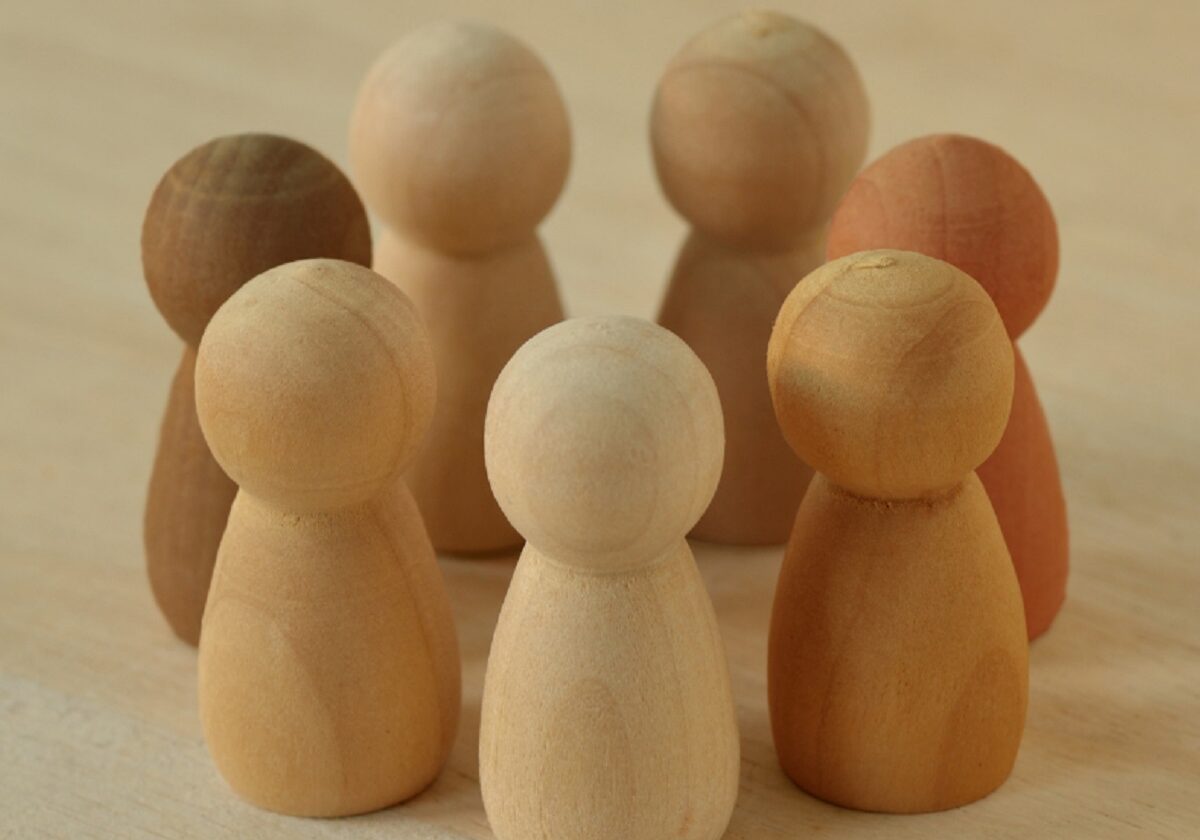 People shaped game counters of various colours standing in a circle