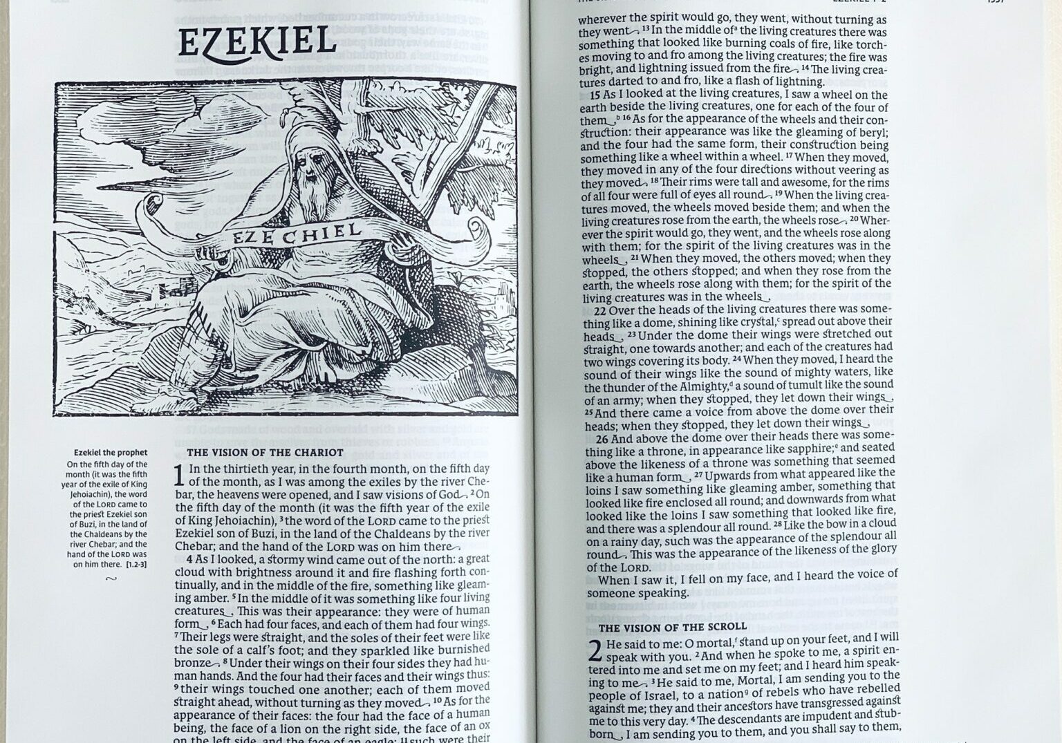 A Bible opened to the first page of the book of Ezekiel showing a drawing of the prophet