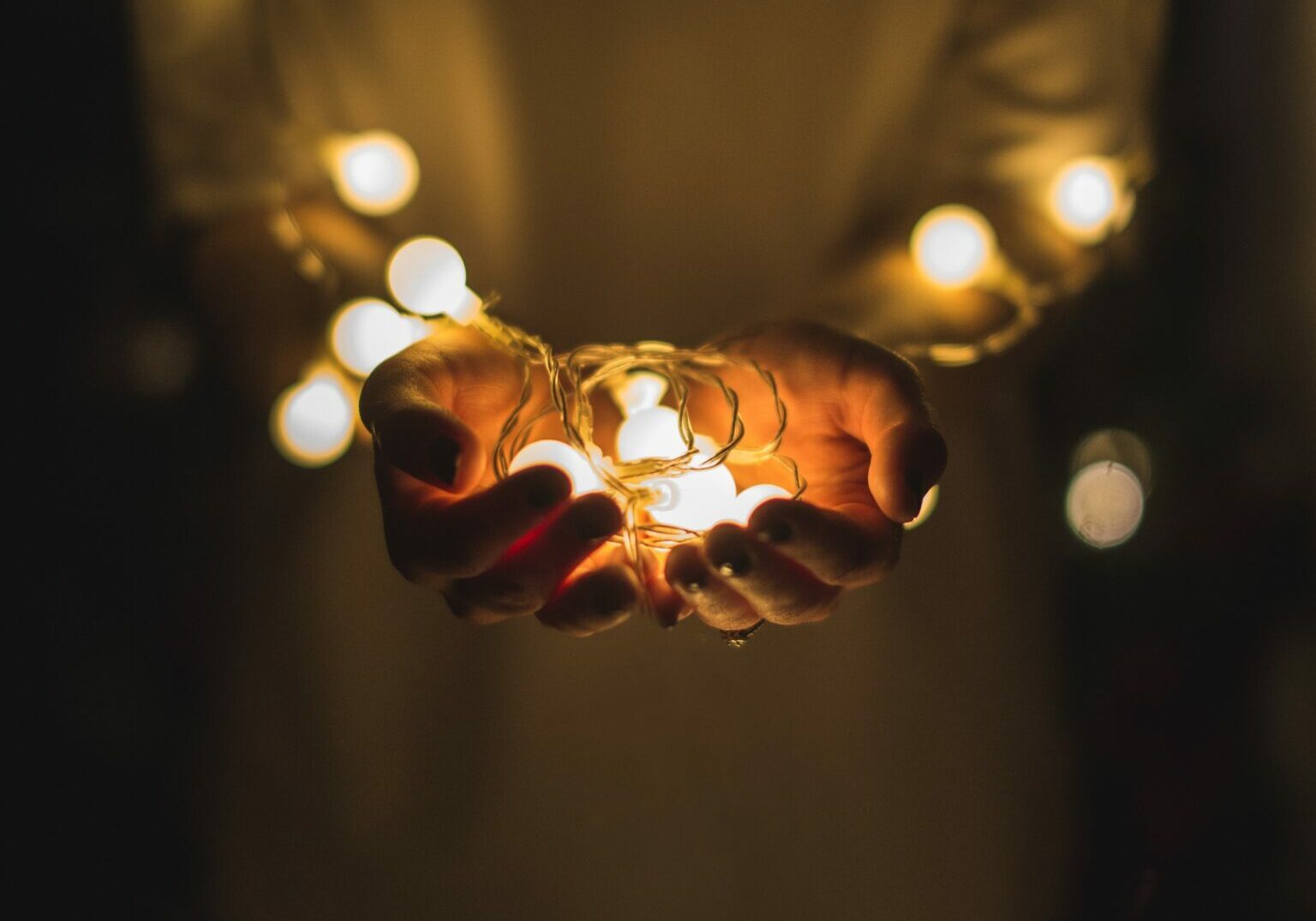 cupped hands holding a ring of lights